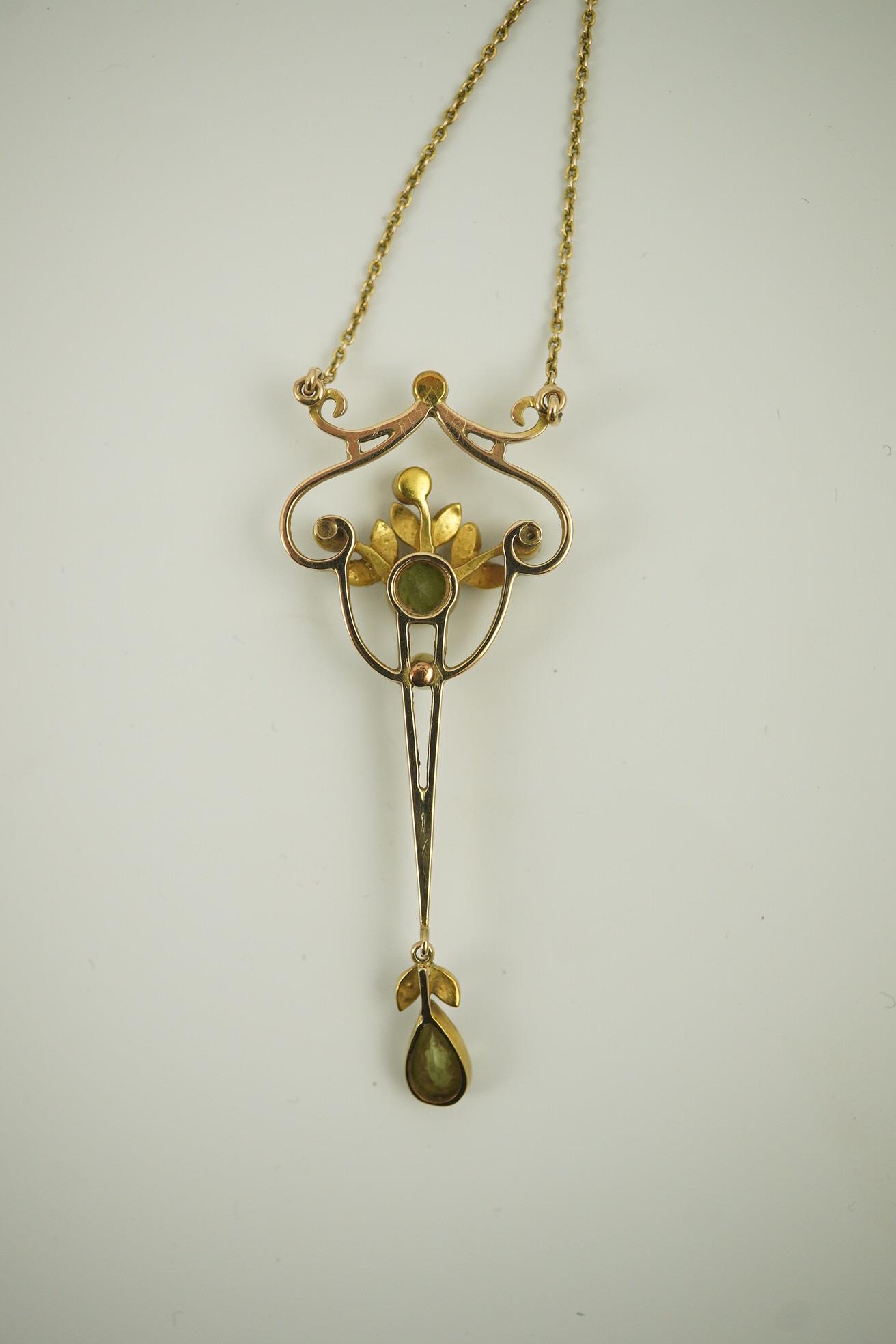 An early 20th century style gold, peridot and seed pearl set drop pendant, on an 18k gold chain